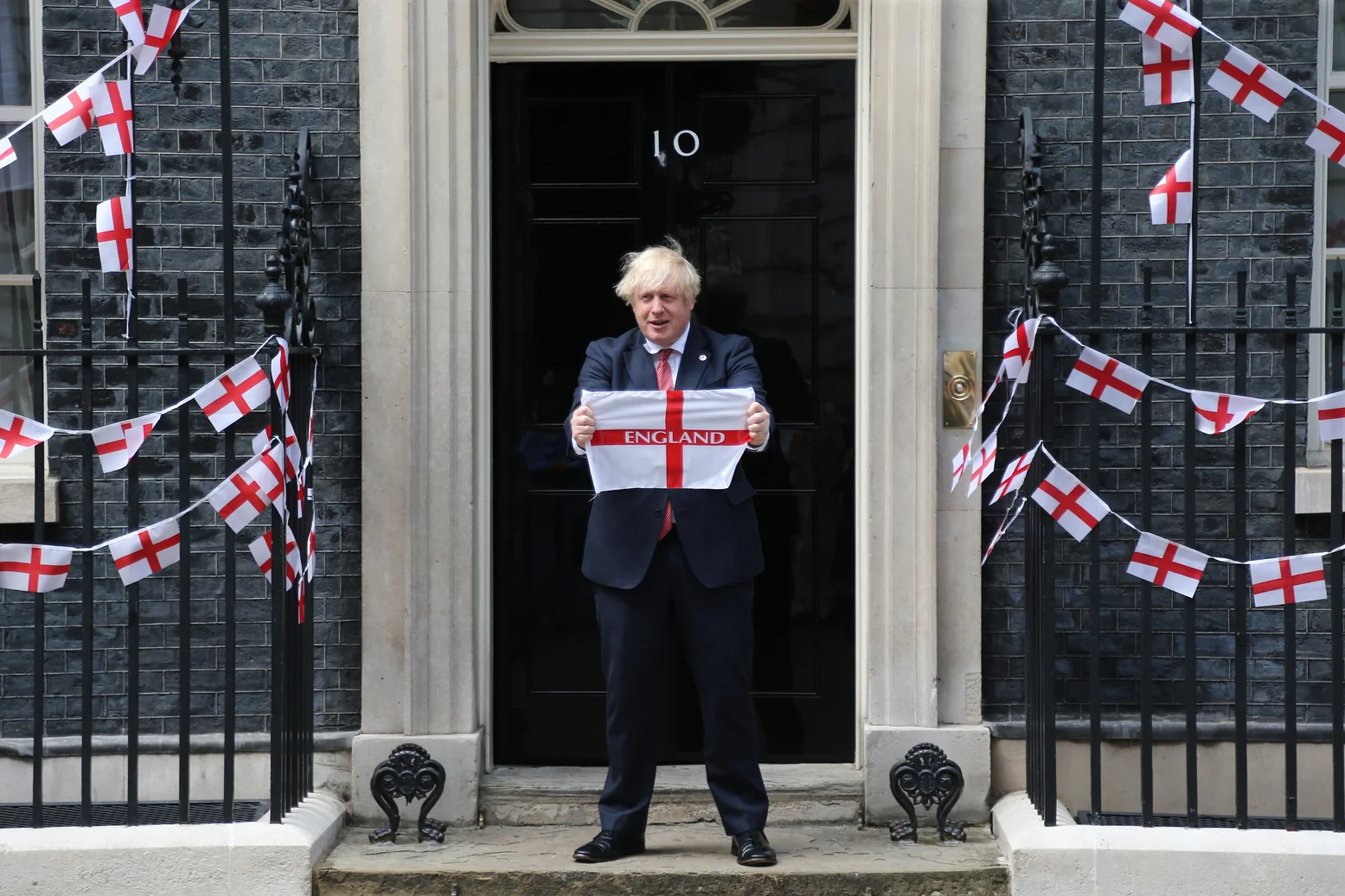 Boris Johnson holds England flag outside Number 10