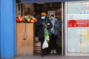 LONDON, UNITED KINGDOM - MAY 2: Two women wearing medical masks against coronavirus (Covid-19) walks out of a shop in Church Street Market in London, England on May 2, 2020. ( İlyas Tayfun Salcı - Anadolu Agency )