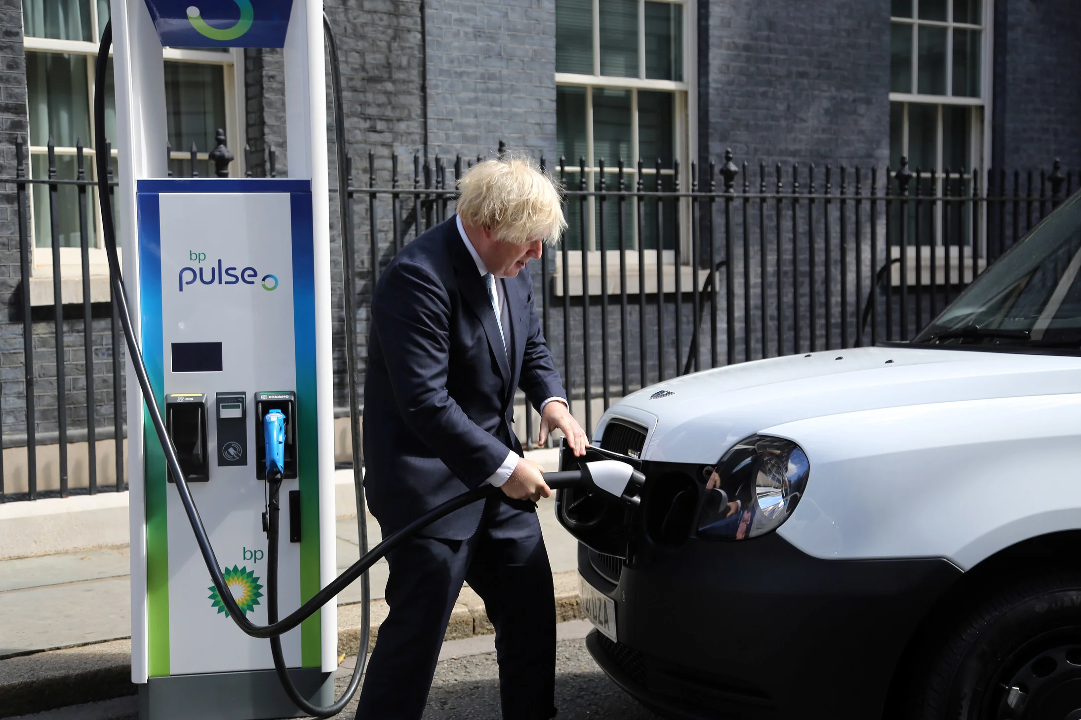UK Prime Minister Boris Johnson poses with electric cars