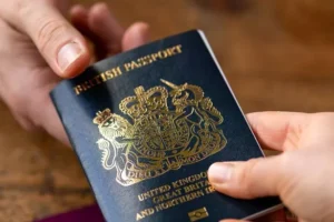 0_man-recieving-new-post-Brexit-blue-British-passport-with-old-European-Union-red-one-the-table-Devon-United-Kingdom