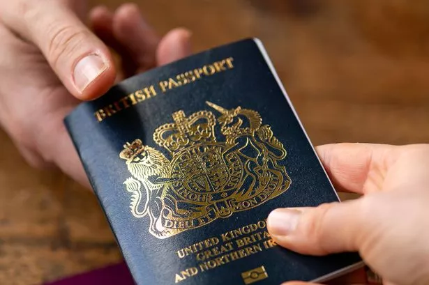 0_man-recieving-new-post-Brexit-blue-British-passport-with-old-European-Union-red-one-the-table-Devon-United-Kingdom